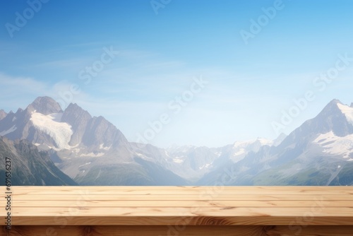 Pristine wooden table foreground with an expansive alpine landscape and clear blue skies