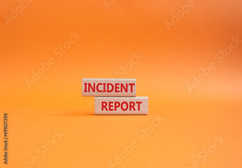 Incident Report symbol. Concept word Incident Report on wooden blocks. Beautiful orange background. Business and Incident Report concept. Copy space