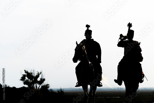 Photography Silhouette of two hungarian hussars on horseback at dusk