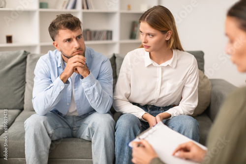 Young couple having therapy session to navigate marital issues indoor photo