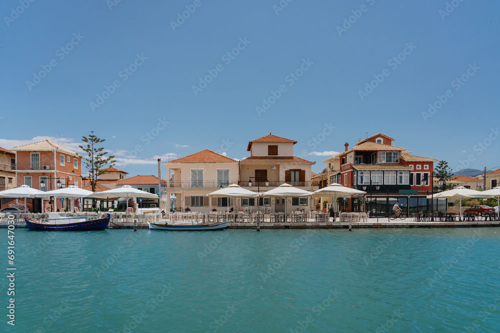 Sunny coastal view with quaint seaside cafes and moored boats
