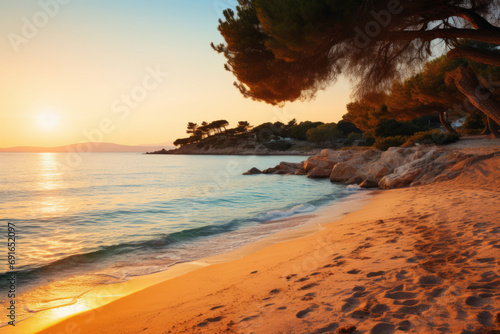 Greece, at sunset. The focus is on the crystal-clear waters and golden sands, framed by olive trees