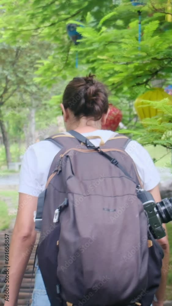 Visua journey as a young woman immerses herself in the enchanting beauty of a Vietnamese natural park, surrounded by vibrant traditional lanterns swaying from trees. This cinematic footage captures a Visua journey as a young woman immerses herself in the enchanting beauty of a Vietnamese natural park, surrounded by vibrant traditional lanterns swaying from trees. This cinematic footage captures a