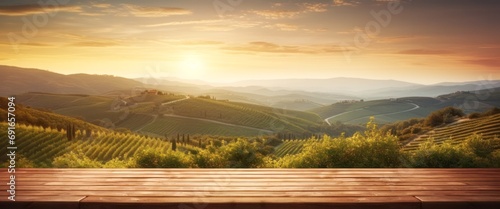 empty wooden table with a view of the early morning sun over a tuscan vineyard