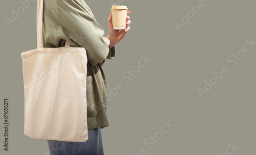 Modern trendy eco tote bag on shoulder. Shopper, green banner background
