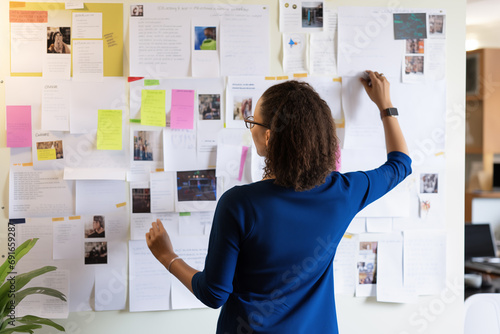 Anonymous Focused Woman Organizing Sticky Notes. Generative AI