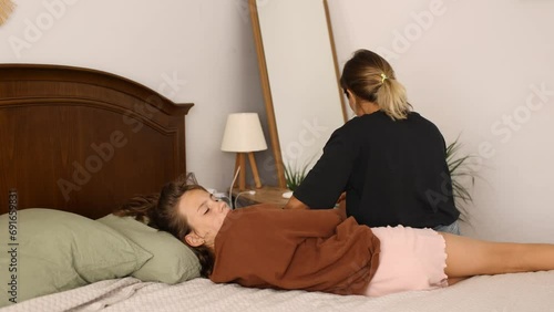 Home scene of mom and daughter fighting about too much time spent in smartphone in internet and social media, daughter turns away from her mom, no understanding between girl teenager and her mom