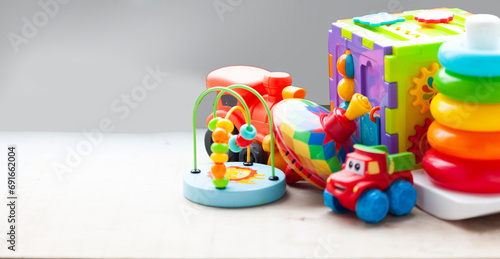 children's toys. wooden rattles, pyramid and wooden blocks on the background. A collection of cute toys for little children. Donation. Foreground