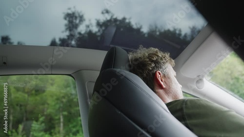 Man Driving Electric Vehicle With Sunroof photo