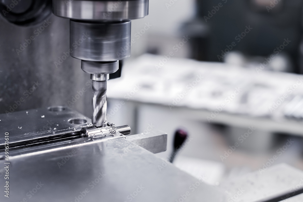 In production, a drill drills into an aluminum steel plate with a drill. A metal drill makes holes in a steel workpiece on an industrial machine. Metalworking industry. Close-up In production, a drill drills into an aluminum steel plate with a drill. A metal drill makes holes in a steel workpiece on an industrial machine. Metalworking industry. Close-up