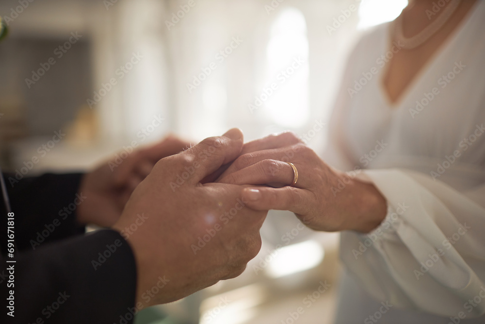 Closeup of mature bride and groom holding hands with focus on golden wedding rings, copy space - obrazy, fototapety, plakaty 