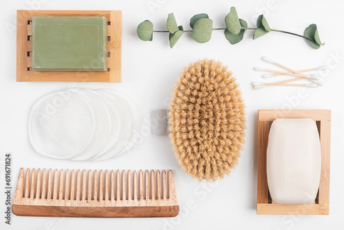 Zero waste beauty products, sustainable bathroom and eco-friendly lifestyle. Organic soap in wooden dish, cotton make-up pads and ears swabs, wood body brush and hair comb. photo
