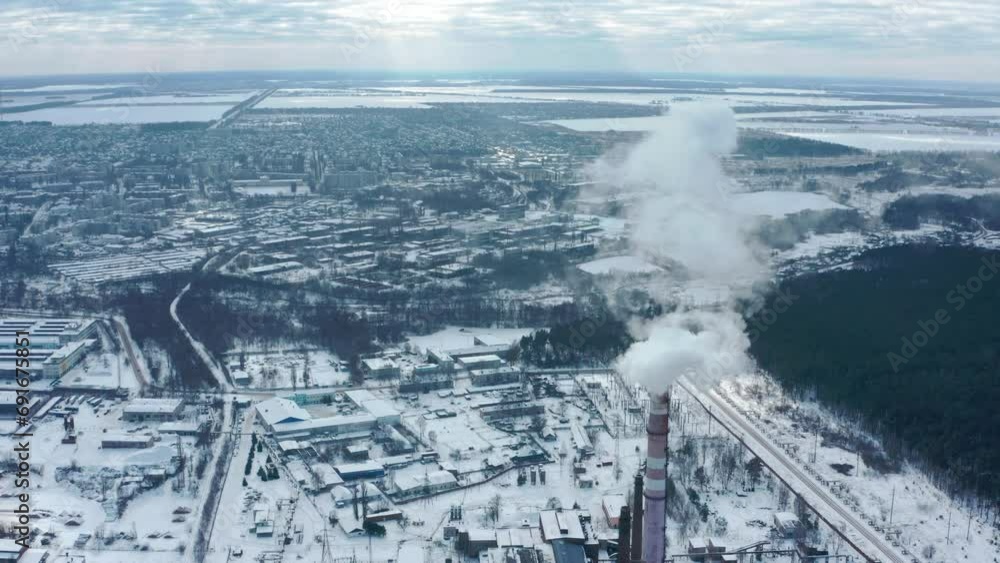 Smoking chimney on the background of the city in winter. Environmental pollution from emissions into the atmosphere. Aerial view of atmospheric emissions. Ukraine 2022, the city of Shostka. Smoking chimney on the background of the city in winter. Environmental pollution from emissions into the atmosphere. Aerial view of atmospheric emissions. Ukraine 2022, the city of Shostka.