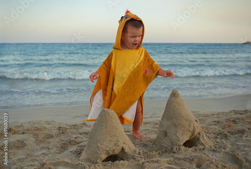 Little boy playing on beach and making sand castles.Child in nature with beautiful sea, sand and blue sky.Happy lifestyle childhood concept