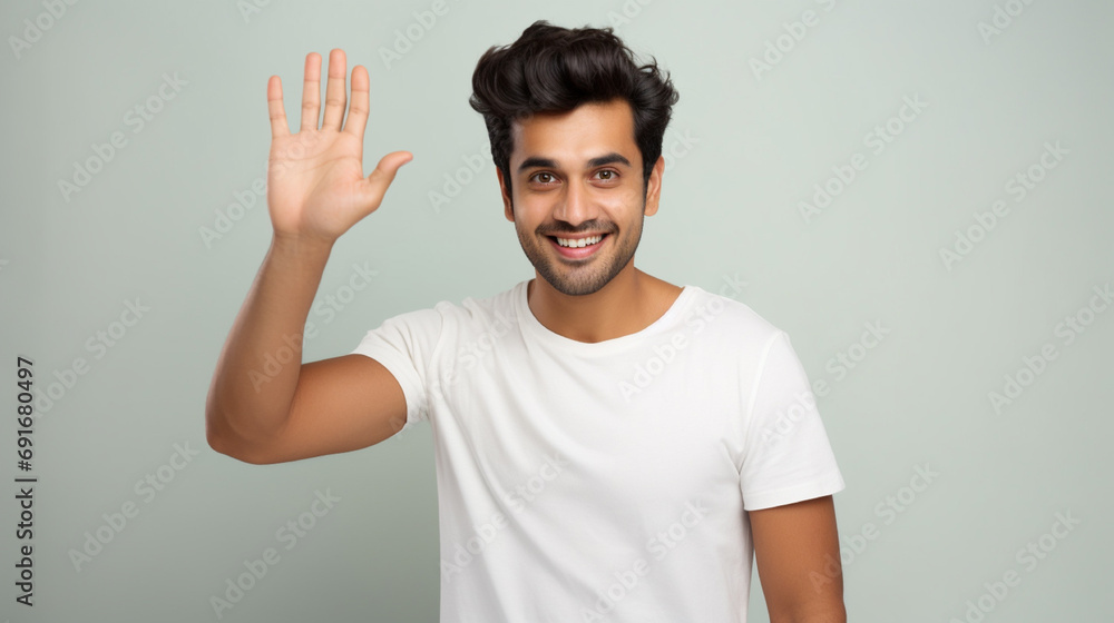 Stock photography portrait of an cute person waving hand hello, wearing a plain white t-shirt, isolated on a plain light blue colored background Stock photography portrait of an cute person waving hand hello, wearing a plain white t-shirt, isolated on a plain light blue colored background