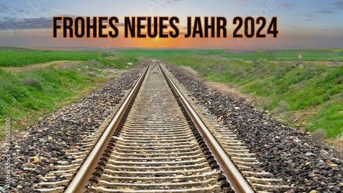 FROHES NEUES JAHR 2024. Sunset in the background over the railway. photo