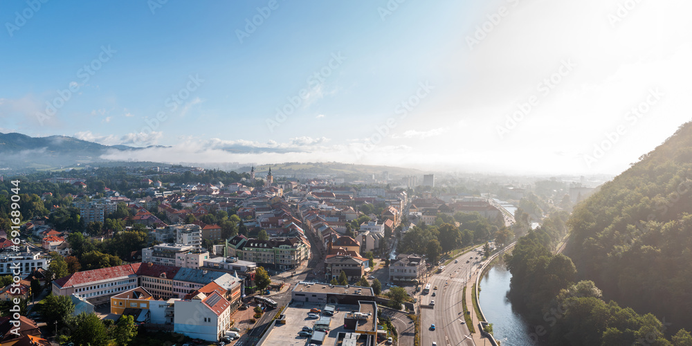 Panoramic aerial cityscape of Banská Bystrica, travel destination city in central Slovakia, located on the Hron River in a long and wide valley encircled by the mountain chains