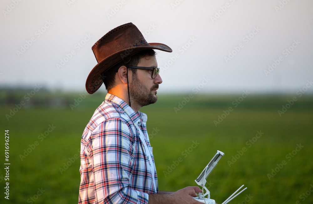 Farmer driving drone above farmland Farmer driving drone above farmland