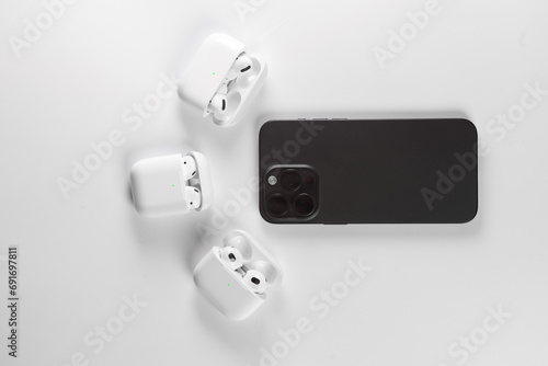 black smartphone with white wireless headphonesб  Iphone 15 pro max Black Titanium photo