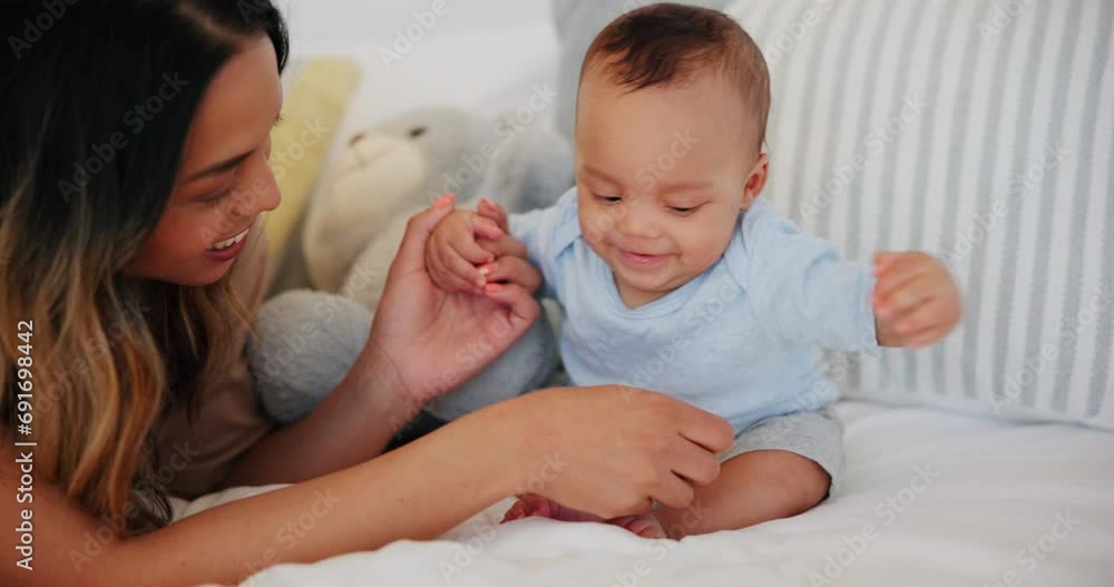 Baby, mother and play with newborn, happy and growth or development on bed at home. Child, woman and support or love, bonding and trust in childhood, fun and silly family, care or comfort in health Baby, mother and play with newborn, happy and growth or development on bed at home. Child, woman and support or love, bonding and trust in childhood, fun and silly family, care or comfort in health
