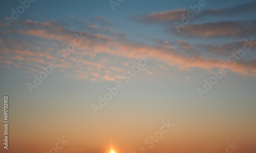 Beautiful sky background - Sunset Sunrise sky with light clouds and real sun. © Anatoliy