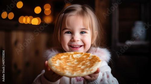 cute little smiling girl eating pancakes  Maslenitsa  holiday  breakfast  lunch  hot crepes  dinner  child  kid  daughter  kitchen  food  holiday  carnival  delicious treat  childhood  portrait  joy