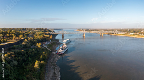 Photography Modern Mississippi cruise boat and traditional riverboat docked by the bluff und