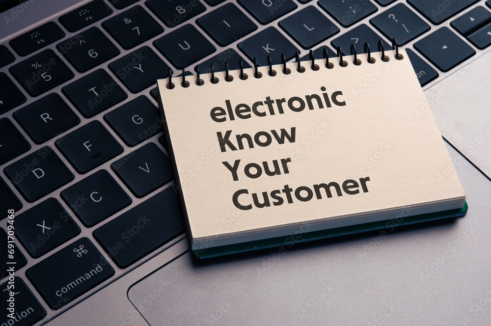 There is notebook with the word electronic Know Your Customer. It is as an eye-catching image. There is notebook with the word electronic Know Your Customer. It is as an eye-catching image.