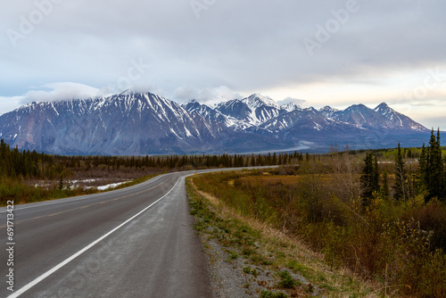 The Alaska Highway curves in front of Mt Archibald as it is going through Kluane National Park, Haines Junction, Yukon, Canada
