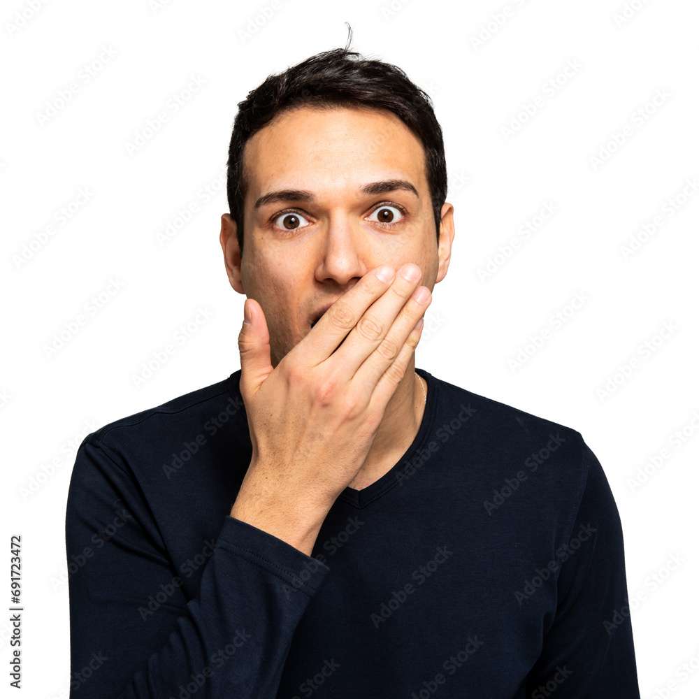 Surprised young man covering mouth with hand Surprised young man covering mouth with hand