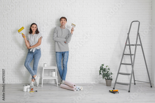 Young couple with paint rol...