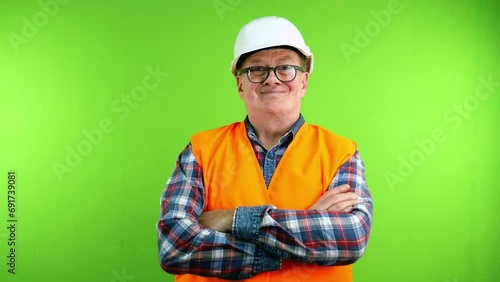 Confident senior friendly builder crossing arms.