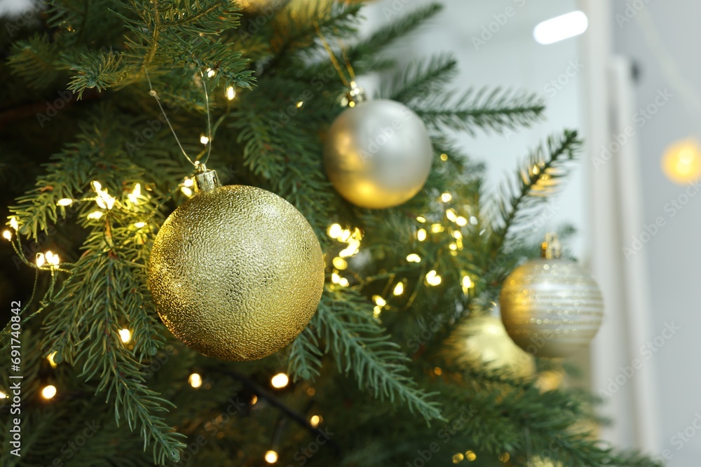 Beautiful decorated Christmas tree with baubles and festive lights, closeup Beautiful decorated Christmas tree with baubles and festive lights, closeup
