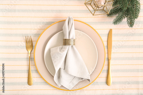 Beautiful table setting with golden cutlery for Christmas dinner