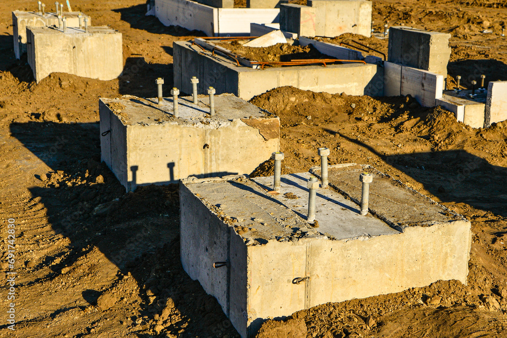 Concrete footings with anchor bolts ready for framing of new commercial building. Concrete footings with anchor bolts ready for framing of new commercial building.