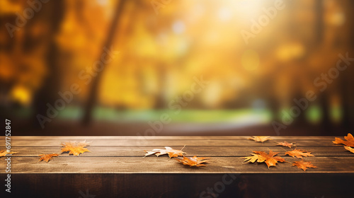 wooden desk on autumn blur abstract natural background