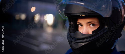 female motorcyclist in a motorcycle jacket and helmet. beautiful woman on a motorcycle ​