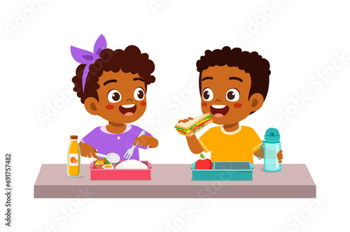 little kid having lunch with friend in school photo