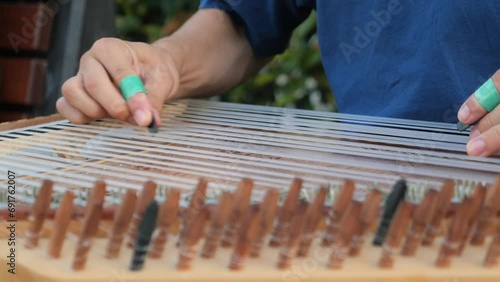 hands of musician playing on cimbalom or dulcimer,  photo
