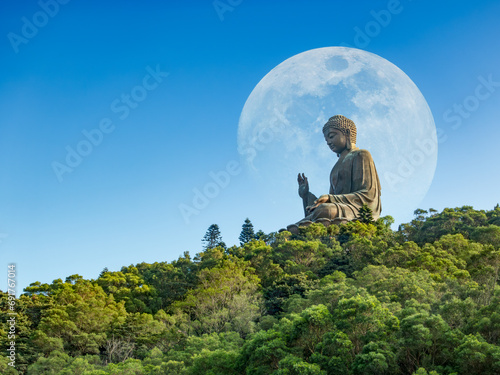 Tian Tan Buddha Statue Po Lin Monastery, Lantau Island, Ngong Ping Village in Hong Kong, scenery on heaven Big buddha in moon and blue sky, religion sacred landmark of tourists and buddhists tourism. photo