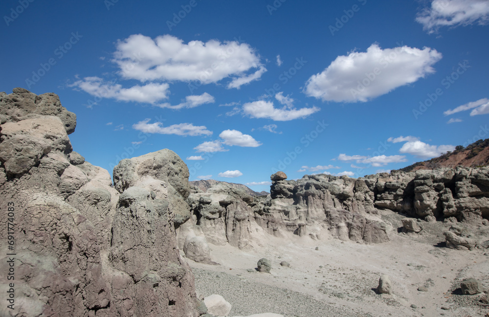Cloudy blue sky over eroded gray hodo formations in Little Book Cliffs National Monument near Grand Junction Colorado United States Cloudy blue sky over eroded gray hodo formations in Little Book Cliffs National Monument near Grand Junction Colorado United States