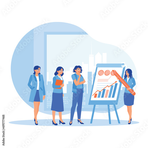 Female leader standing making a flip chart presentation about the company's business strategy. Work team brainstorming and discussing ideas during meetings in the office. Briefings concept.