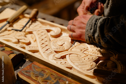 Принти на полотні In this captivating scene, a masterful carpenter demonstrates meticulous attention to detail while crafting intricate designs on wood, showcasing exceptional woodworking artistry and skill