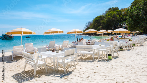 Koh Samet Island Rayong Thailand, beach chairs sunbed with umbrellas at the white tropical beach of Samed Island with a turqouse colored ocean and a blue sky © Fokke Baarssen