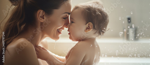Mother and baby bonding, mommy and infant taking a bath, family relationship concept, wide-shot web banner photo