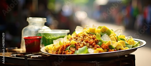 Indonesian street vendors sell rujak fruit salad. photo