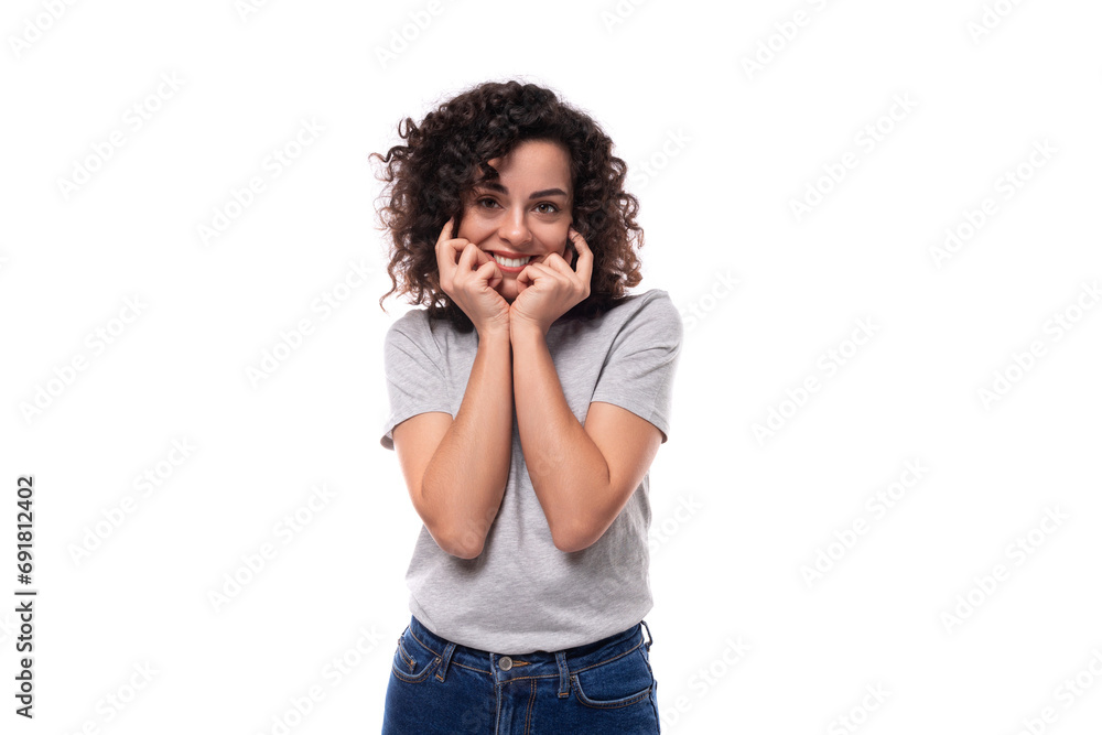 young slender brunette curly woman is dressed in a gray basic corporate color t-shirt. clothing identity and branding concept young slender brunette curly woman is dressed in a gray basic corporate color t-shirt. clothing identity and branding concept