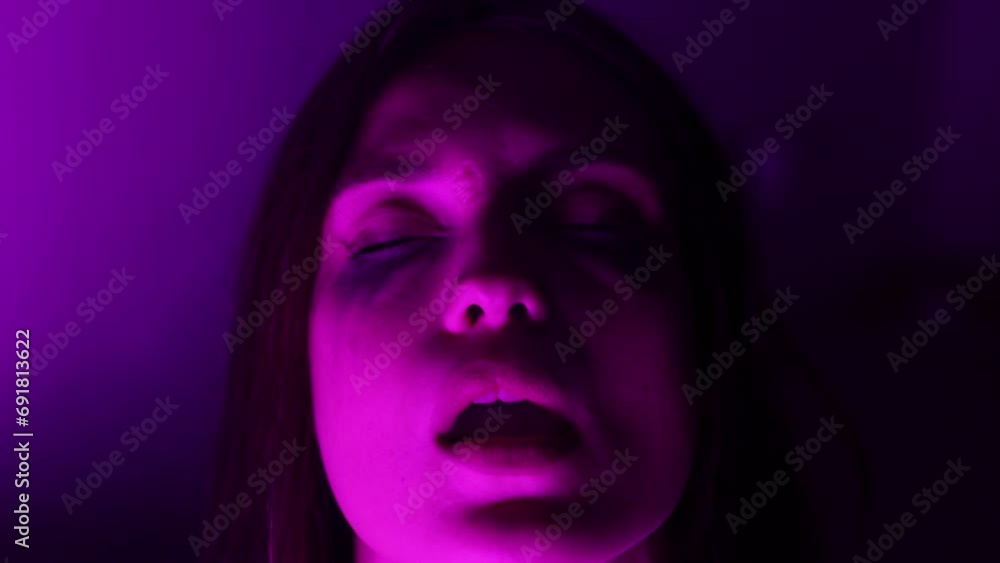 woman drug addict exhales smoke at neon color party woman drug addict exhales smoke at neon color party