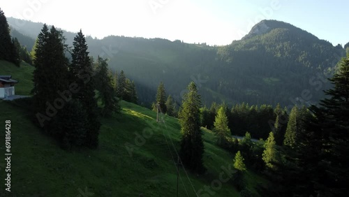 A power line and a steep rope way during sunset in the Alps in Lofer, Austria photo