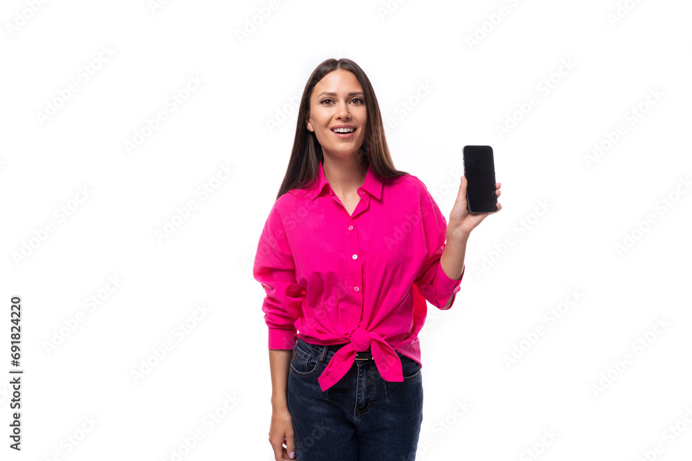 fashionable slim young employee office woman dressed in a pink shirt shows the smartphone screen fashionable slim young employee office woman dressed in a pink shirt shows the smartphone screen